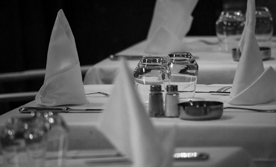 Elegant restaurant dining table with place settings and ambient lighting